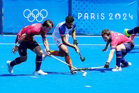 Abhishek, center, Spain's Jose Basterra, left, and Gerard Clapes compete for the ball during bronze medal match